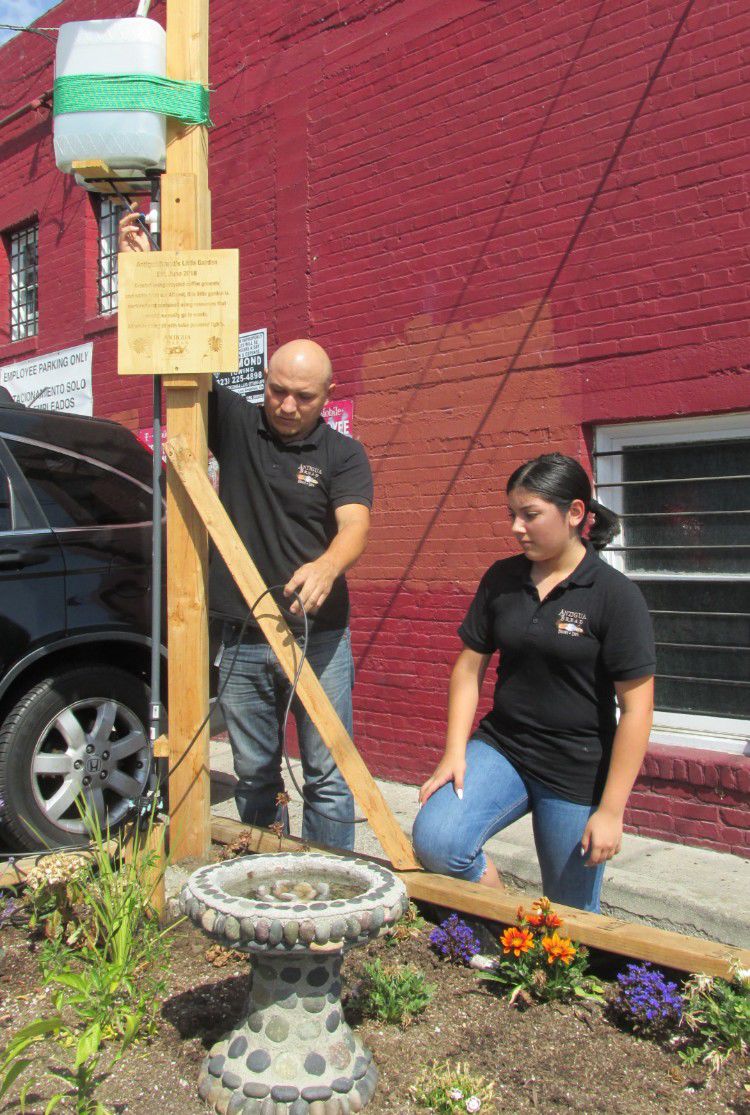 Miguel and Kathy Hernandez with garden and AC water.jpg